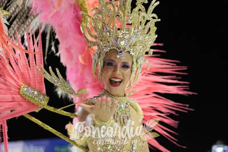 Integrante de comparsa de Concordia con su fantasía de carnaval color rosa y dorado.