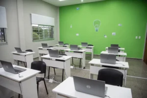 Filas de escritorios con notebooks Dell en un espacio de formación digital y tecnología educativa en uso activo